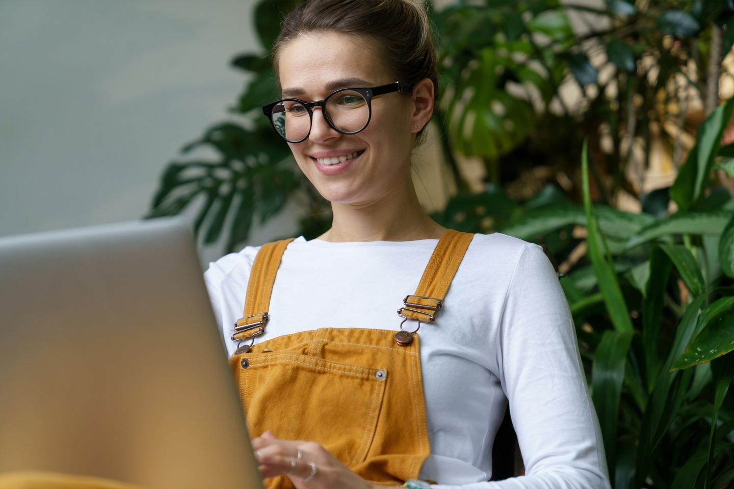 Person med laptop på fanget som sitter og ser på skjermen